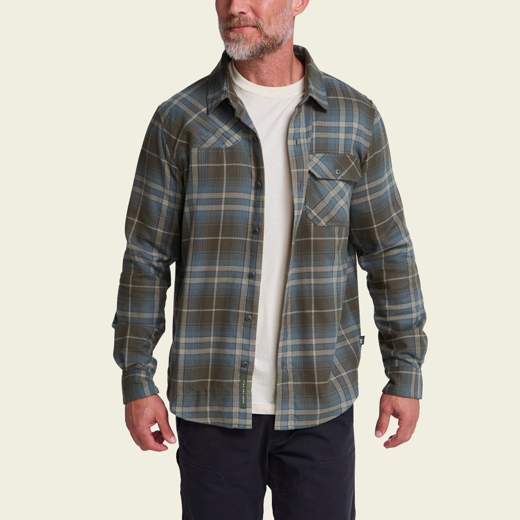 Men's plaid flannel shirt in olive and blue, worn open over white tee, front view