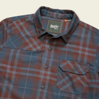 Men's plaid flannel shirt with chest pocket, snap buttons, and spread collar, angled view