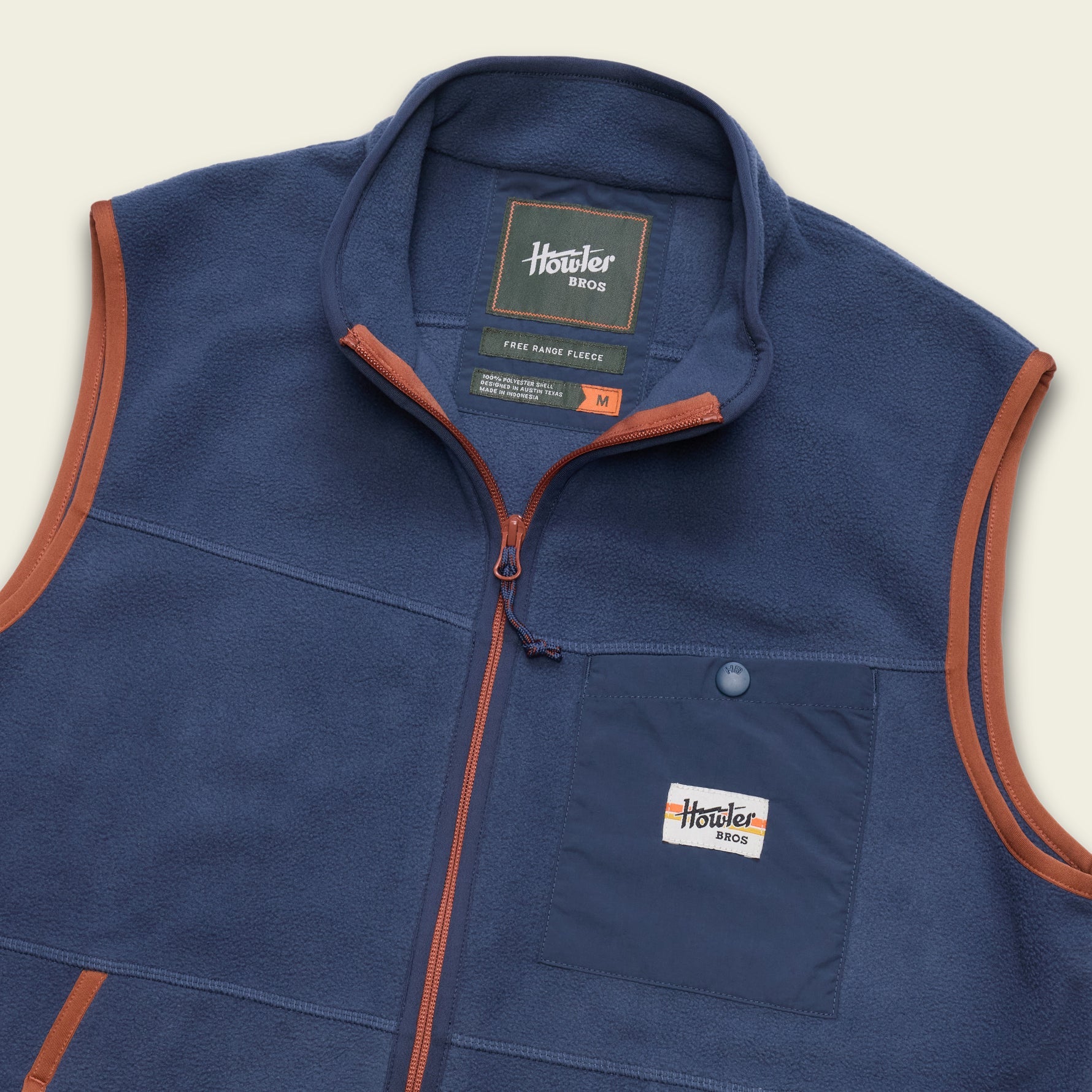 Men's fleece vest with full zip, chest pocket, and contrasting orange trim, angled front view