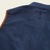 Close-up detail of fleece vest back shoulder showing chest pocket and zip pull
