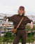 Woman wearing a dark brown pullover hoodie with kangaroo pocket, leaning on a railing outdoors
