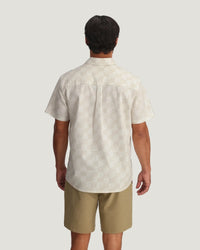 Light colored short sleeve button-up shirt with subtle print pattern, back view