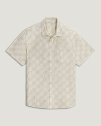 Light colored short sleeve button-up shirt with shell pattern print, front view