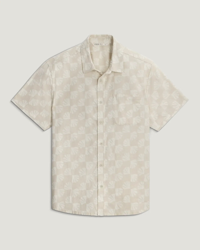 Light colored short sleeve button-up shirt with shell pattern print, front view