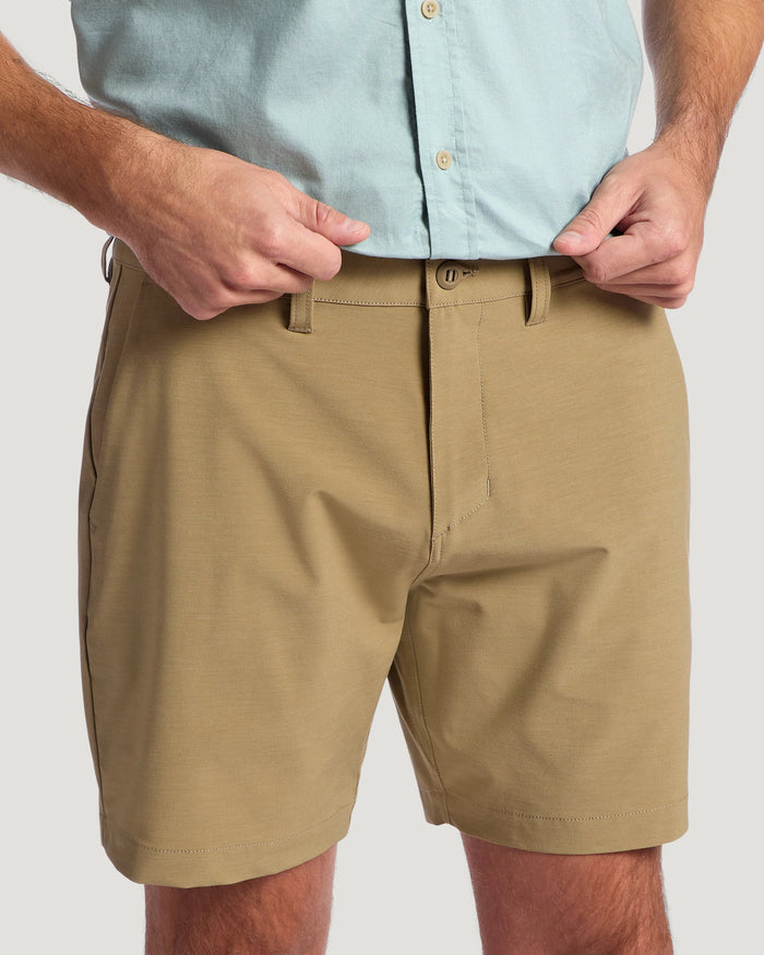 Men's khaki hybrid shorts with button closure and belt loops, front waistband view