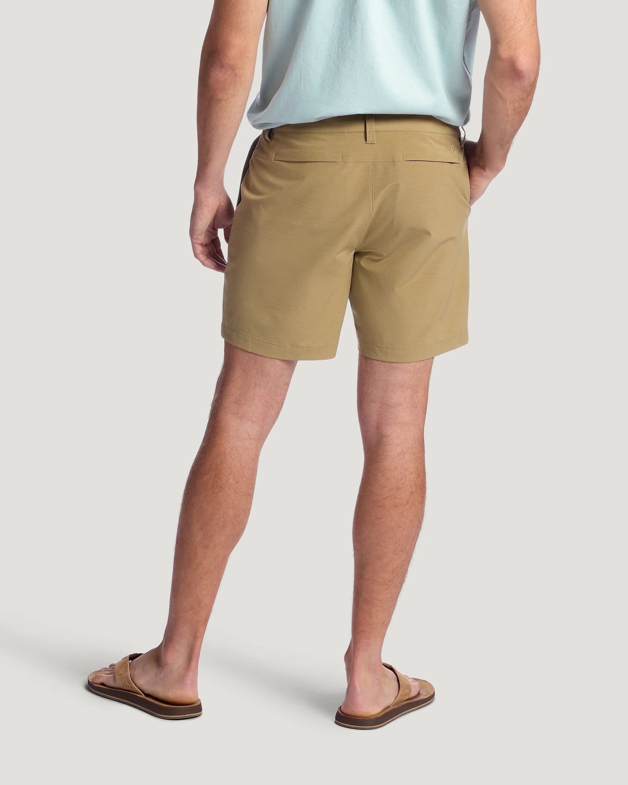 Men's khaki hybrid shorts shown from back view with clean studio background