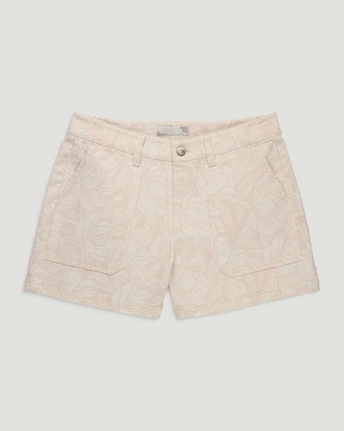 Light colored twill shorts with tropical print, front view showing pockets and button closure