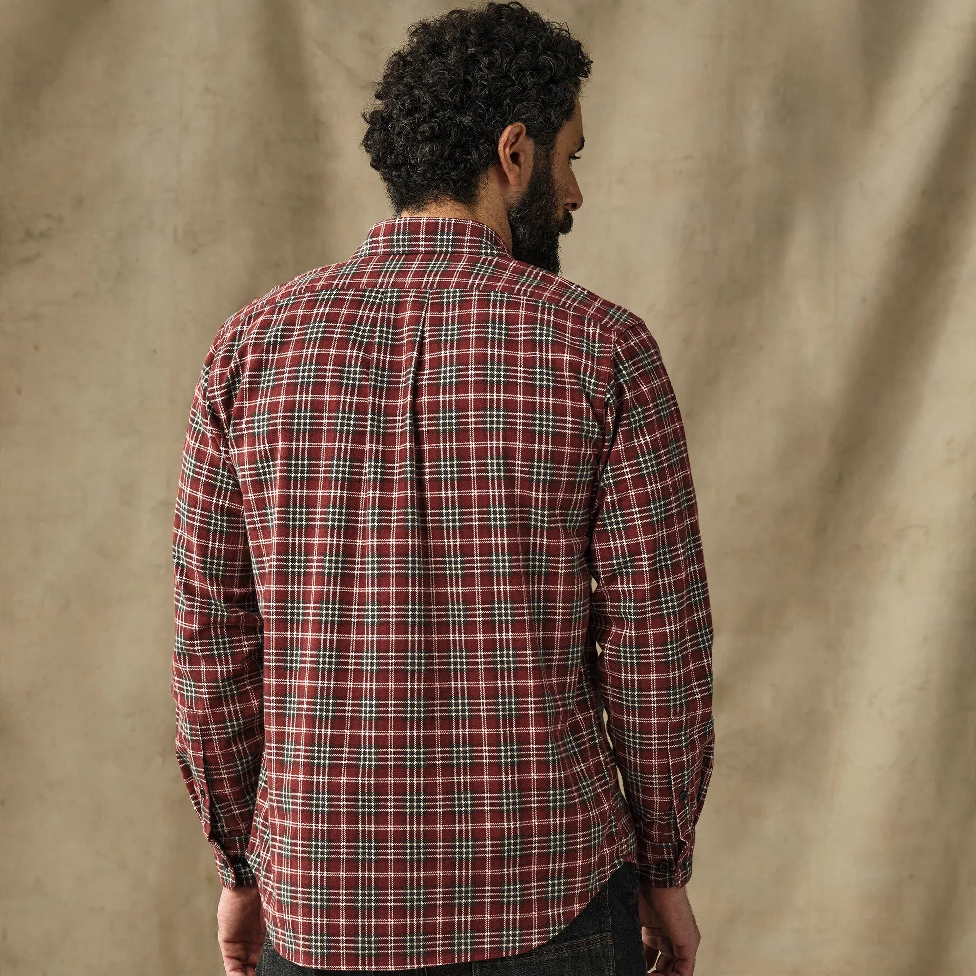 Men's plaid flannel shirt in red tartan pattern, back view on model