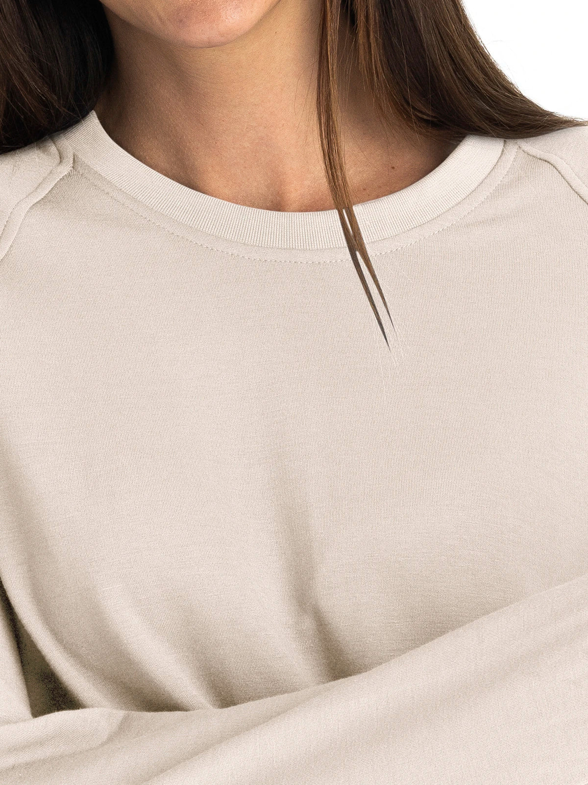 Close-up detail of women's crewneck fleece sweatshirt with ribbed collar, light beige color
