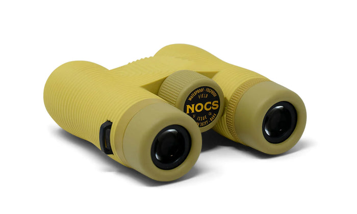Compact yellow-green binoculars with rubberized grip and dual eyepieces, back-left angle view