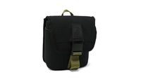 Small black canvas field pouch with flap closure, buckle strap, and olive green webbing