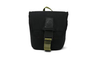 Small black canvas pouch with olive green buckle strap and top carry handle, front view