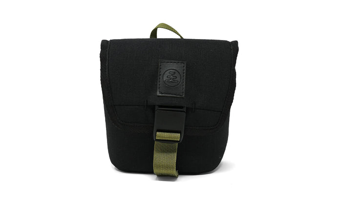 Small black canvas pouch with olive green buckle strap and top carry handle, front view