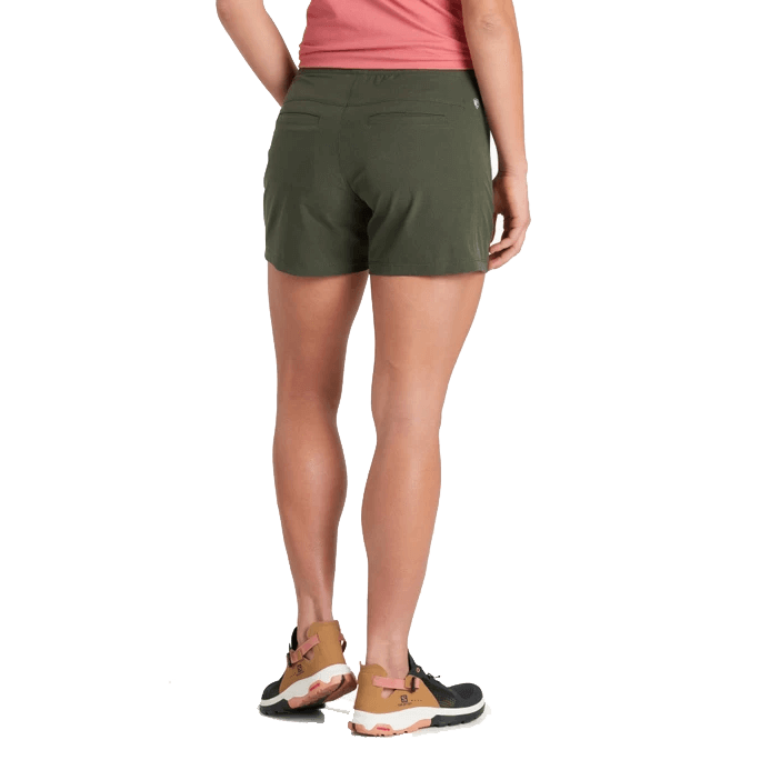 Women's olive green athletic shorts shown from back view with pink top