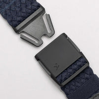 Navy blue webbing belt with geometric pattern and black plastic buckle, buckle unclasped