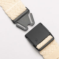Cream webbing belt with quick-release plastic buckle shown unclasped on white background