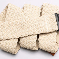 Light beige woven belt with braided texture pattern laid flat on white background