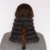 Black quilted puffer neck gaiter worn by model, back view showing braid