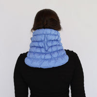 Puffer neck gaiter in light blue worn on model, back view showing quilted panels