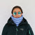 Light blue quilted neck gaiter worn as a neck warmer on a model in a winter jacket