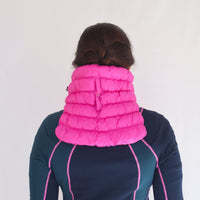 Bright pink quilted puffer neck gaiter worn by model, back view showing full coverage
