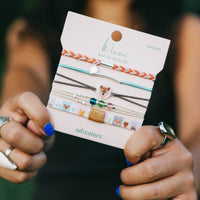 Set of five hair tie bracelets on display card featuring bear charm, beads, and braided designs