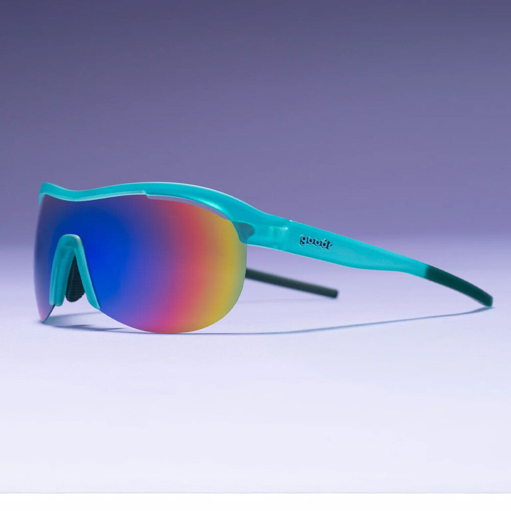 Wraparound athletic sunglasses with turquoise frame and rainbow mirrored lens on gradient background