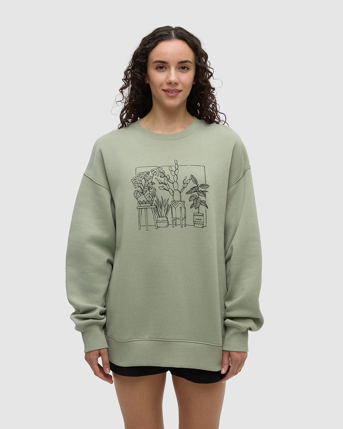 Light green crew neck sweatshirt with black line drawing of potted plants