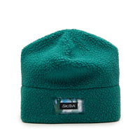 Teal sherpa fleece beanie hat with cuffed brim and woven label, front view