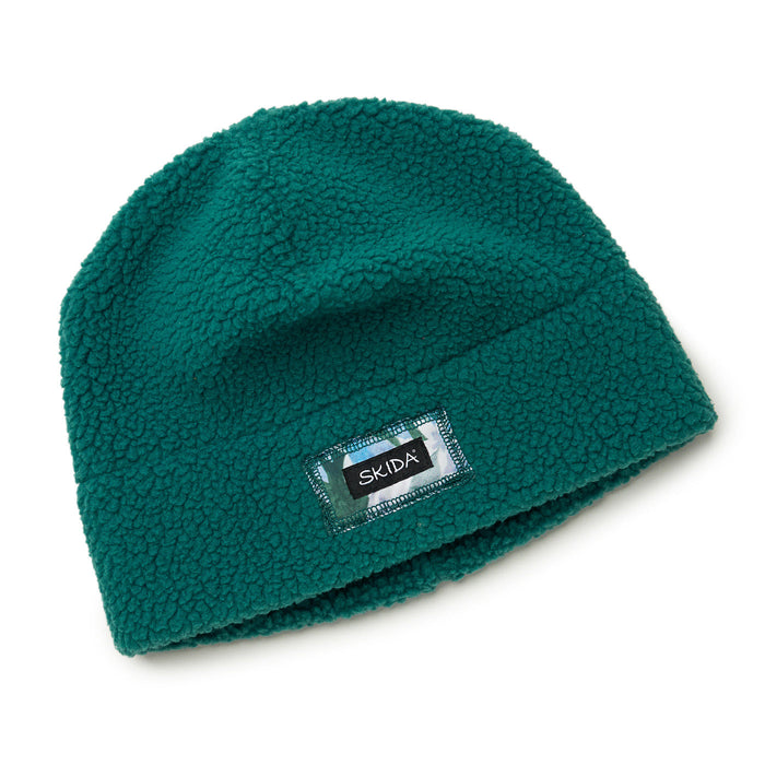 Teal sherpa fleece beanie hat with cuffed brim and small brand label patch