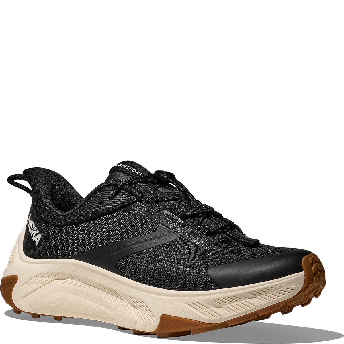Black athletic running shoe with cream midsole and brown rubber outsole, side view