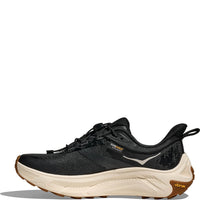 Black athletic running shoe with cream midsole and gum rubber outsole, side profile view