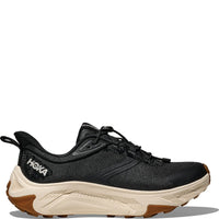 Black athletic running shoe with cream midsole and brown outsole, side profile view