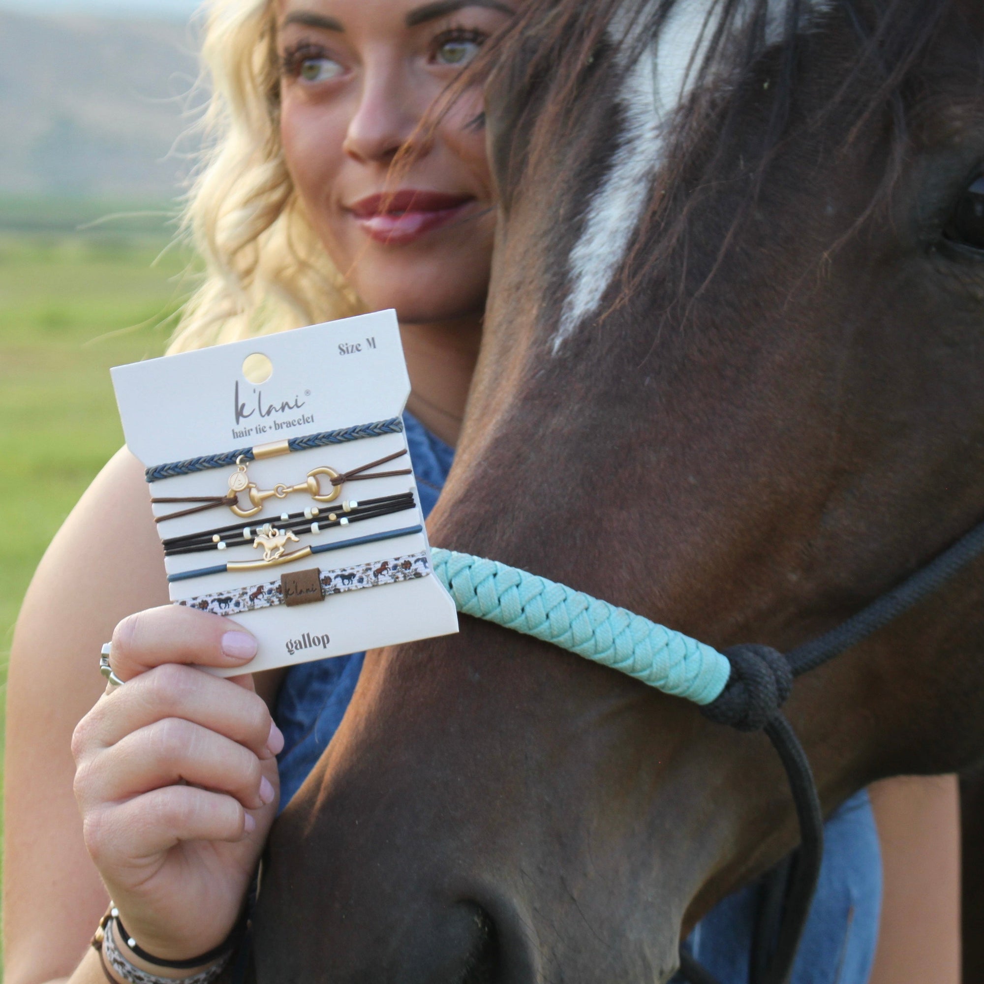 Set of four hair tie bracelets with equestrian charms displayed on packaging card, held by model near horse