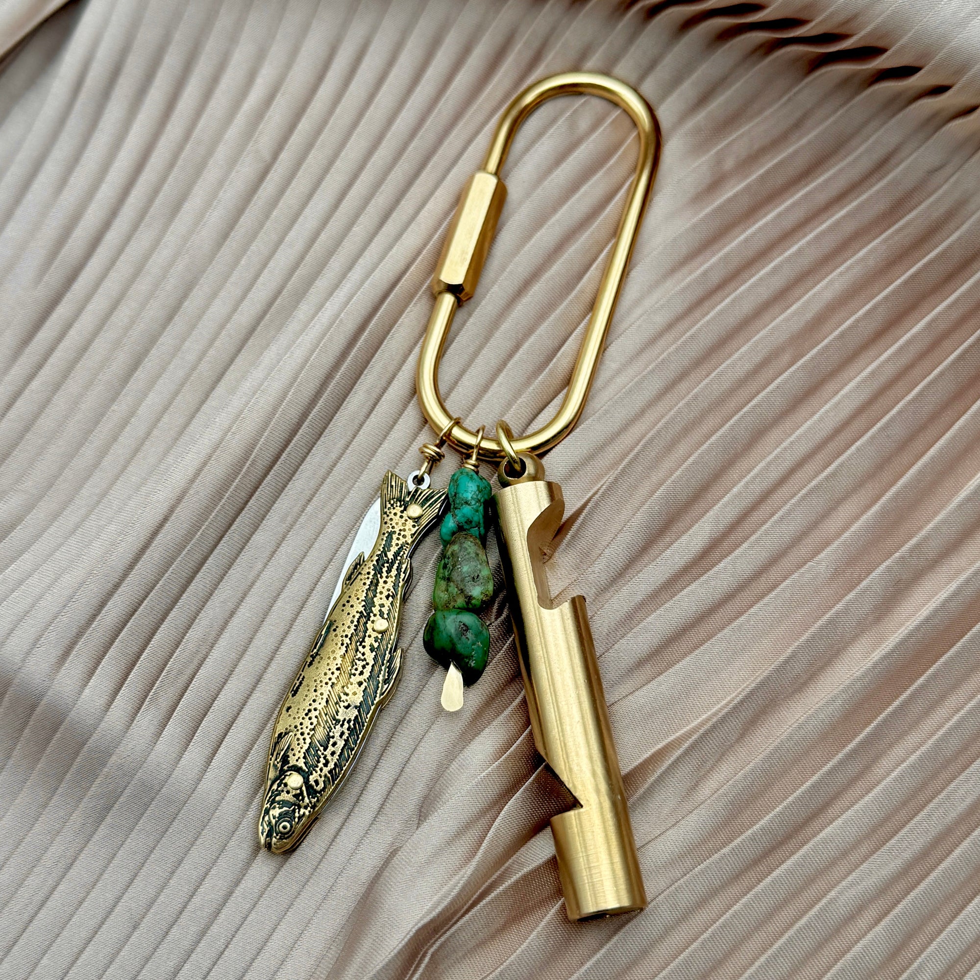 Gold brass carabiner purse charm with fish knife, turquoise stones, and cylindrical whistle pendants