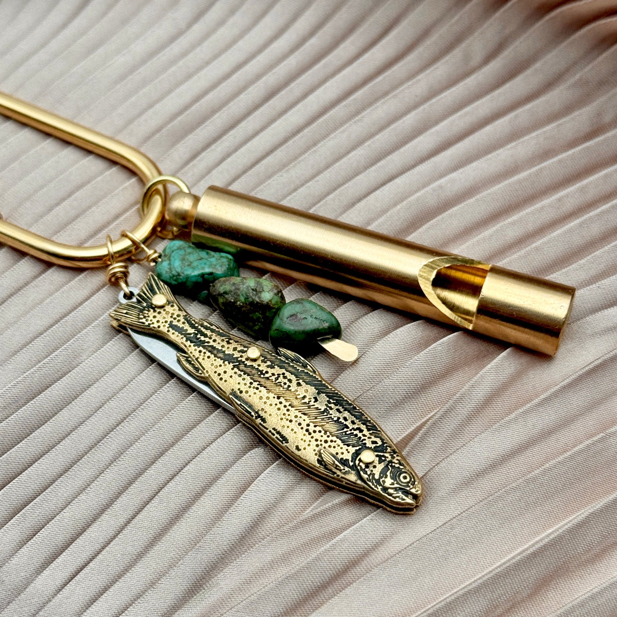 Gold brass purse charm with fish knife pendant, turquoise stones, and cylindrical whistle