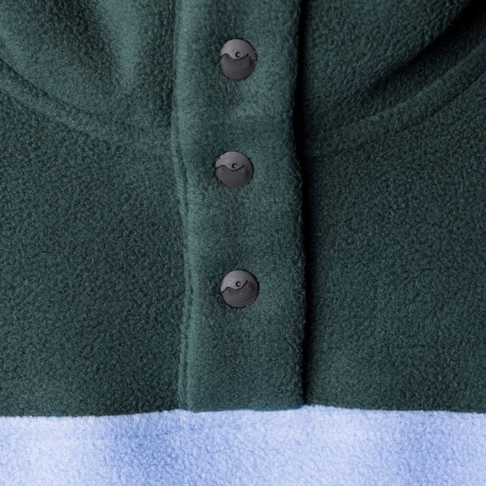 Dark green fleece jacket detail showing three decorative buttons on front placket
