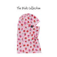 Kids balaclava with strawberry print pattern on pink background, flat lay view