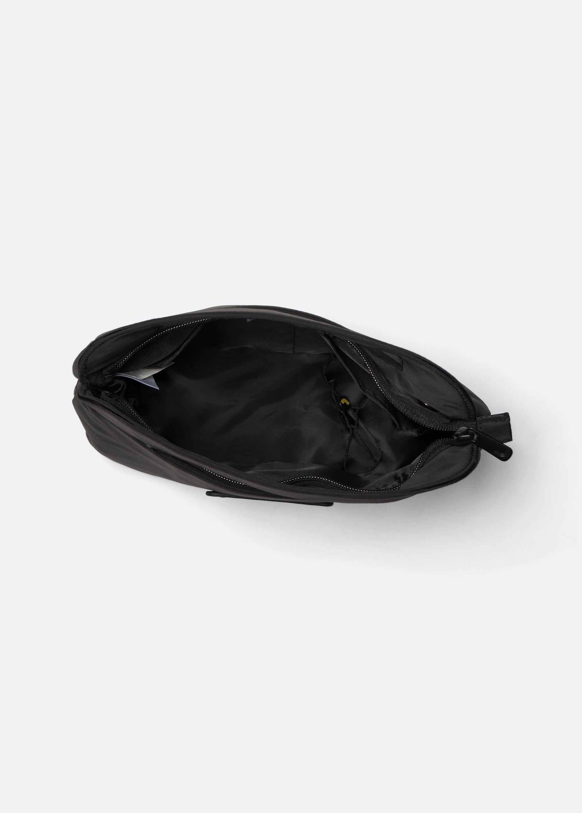 Black crossbody bag open top view showing interior lining and zipper compartments
