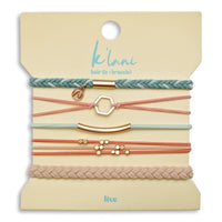 Set of five hair tie bracelets in pastel teal, pink, and beige with rose gold charms on display card