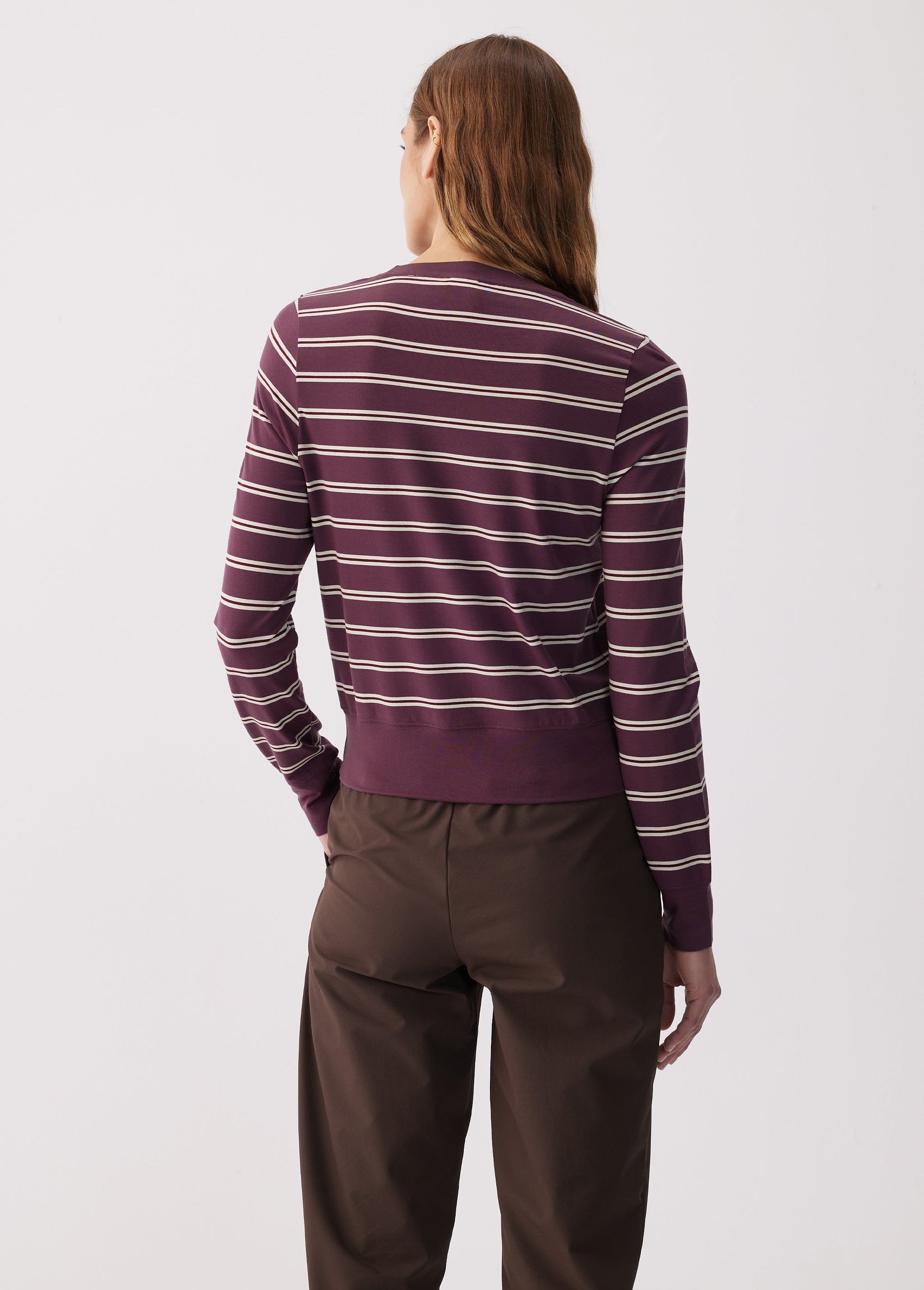 Women's striped long sleeve top in dark purple with cream stripes, back view on model