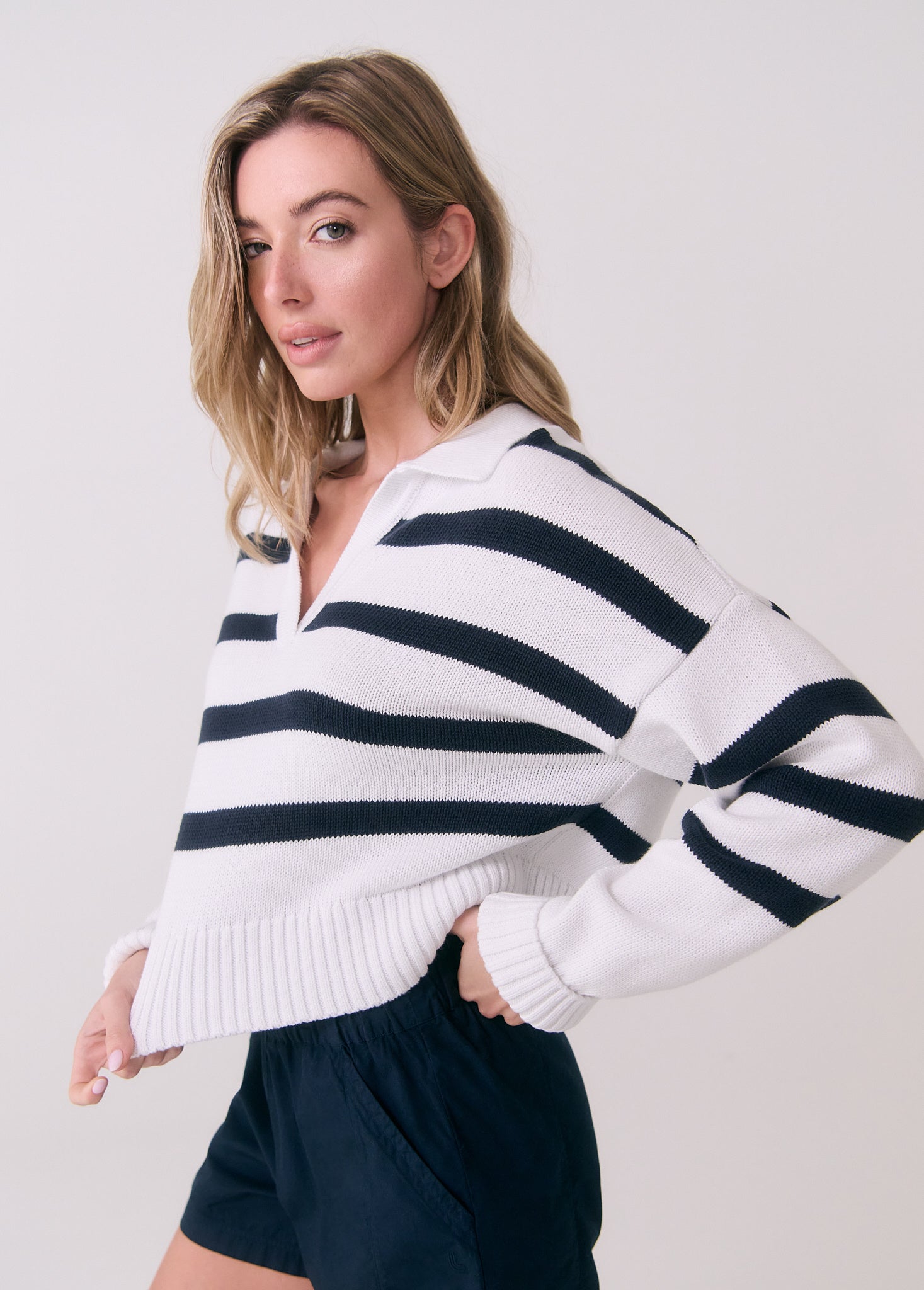Striped polo sweater with white and navy horizontal stripes, v-neck collar