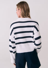 White striped polo sweater with navy horizontal stripes, back view on model
