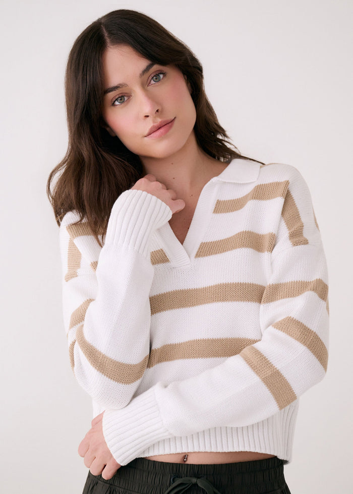 White striped polo sweater with v-neck and ribbed cuffs on model