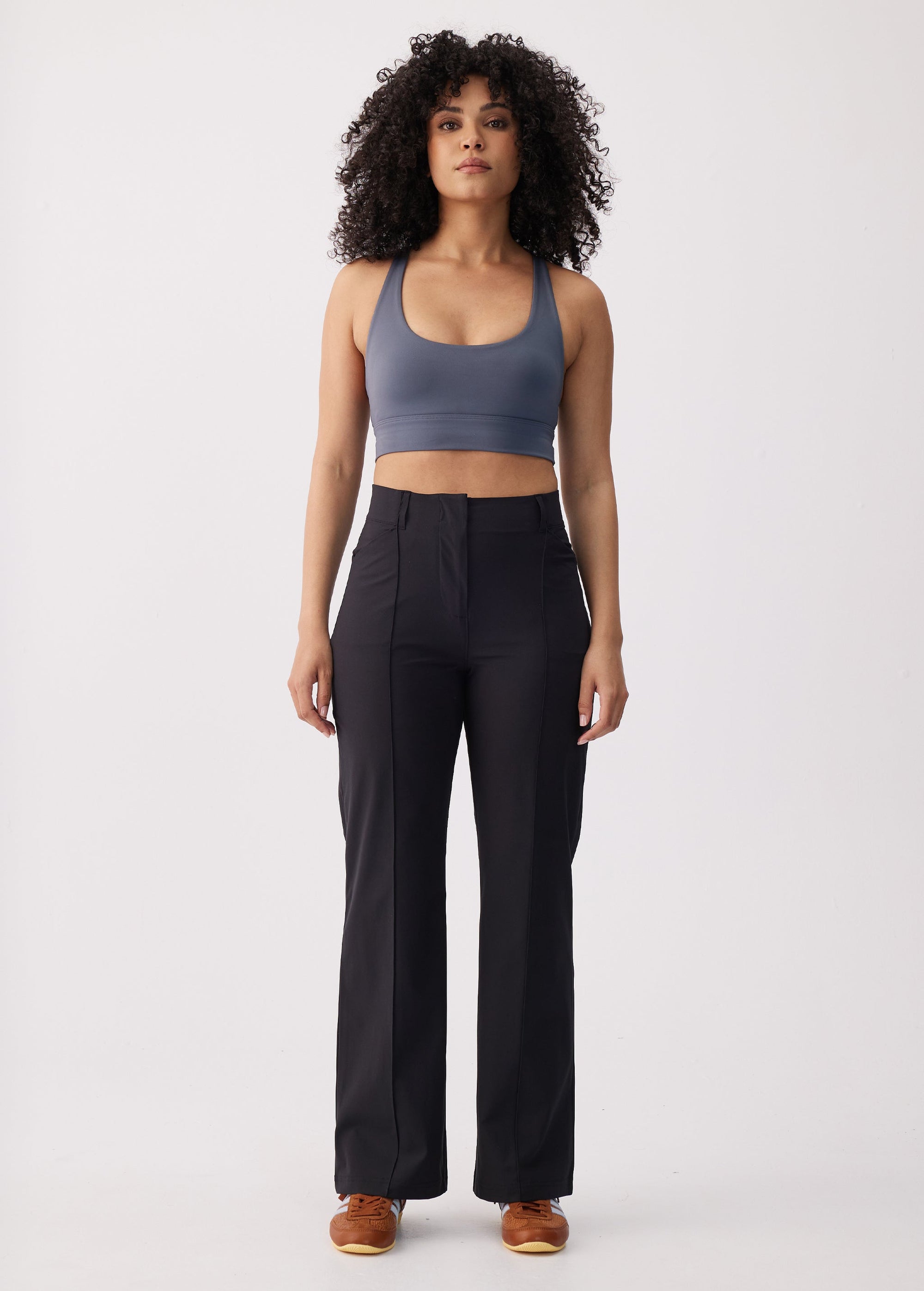 Women's high-waist wide-leg black travel trousers with front seam detail, front view