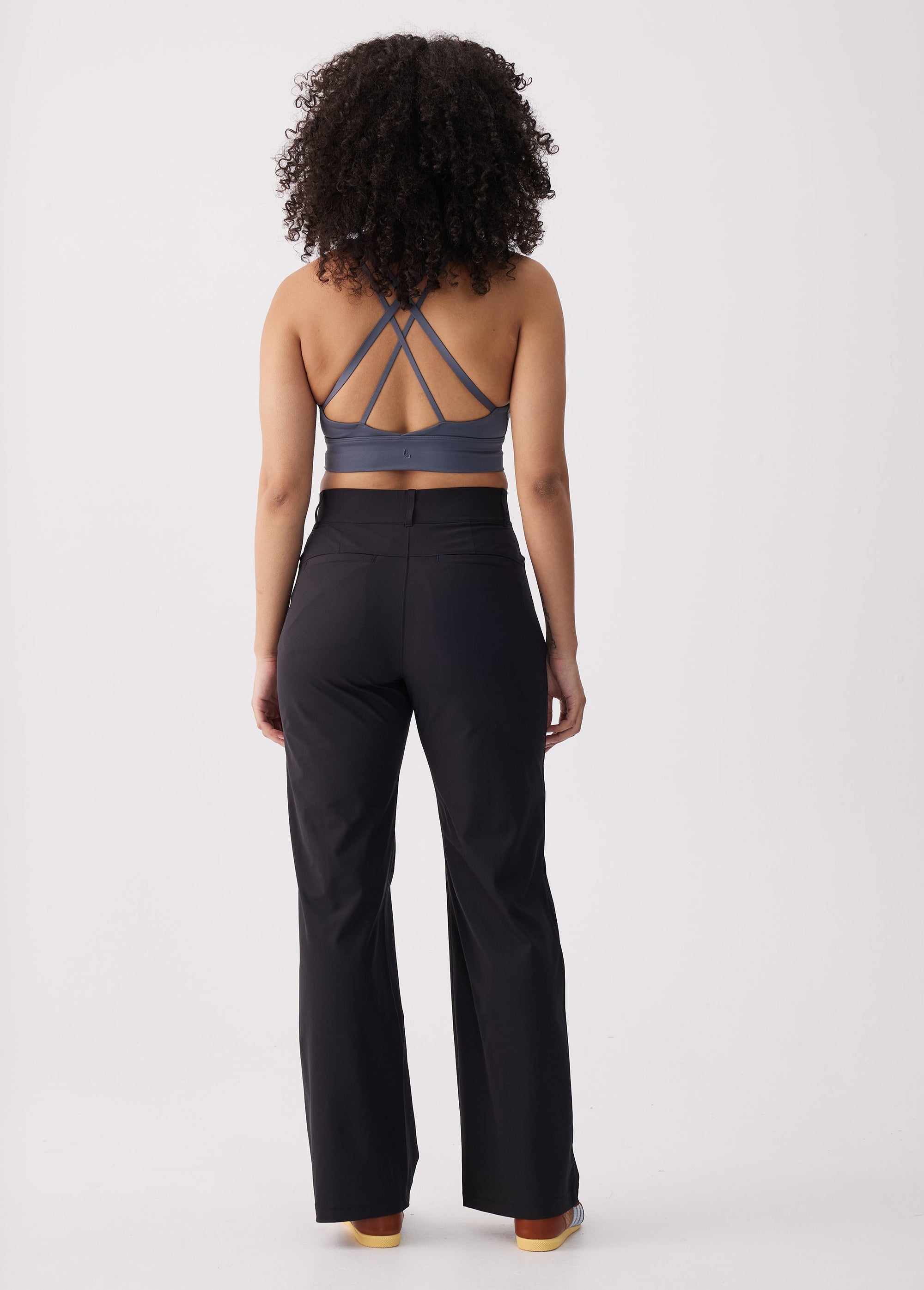 Black wide-leg travel trousers, back view on model with high waistband