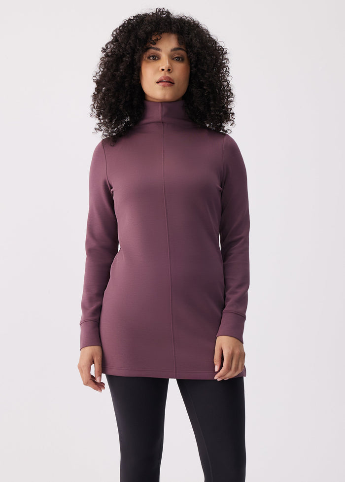 Women's long-sleeve turtleneck tunic top with seam detail, front view on model