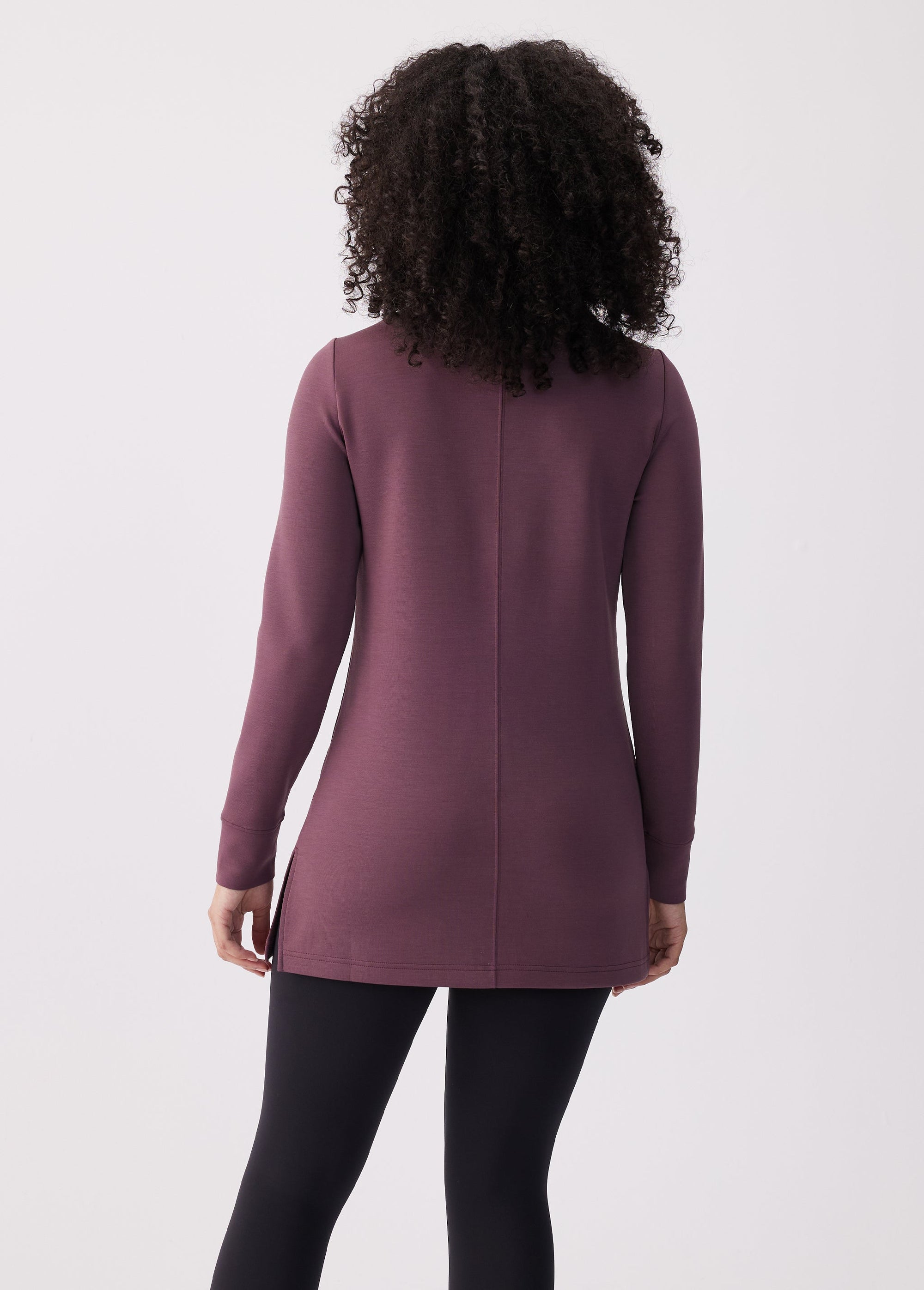 Women's long-sleeve tunic top in deep mauve, back view, with center seam detail and side slits