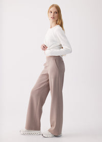 Wide-leg high-waist pants in taupe, side view on model with white long-sleeve top