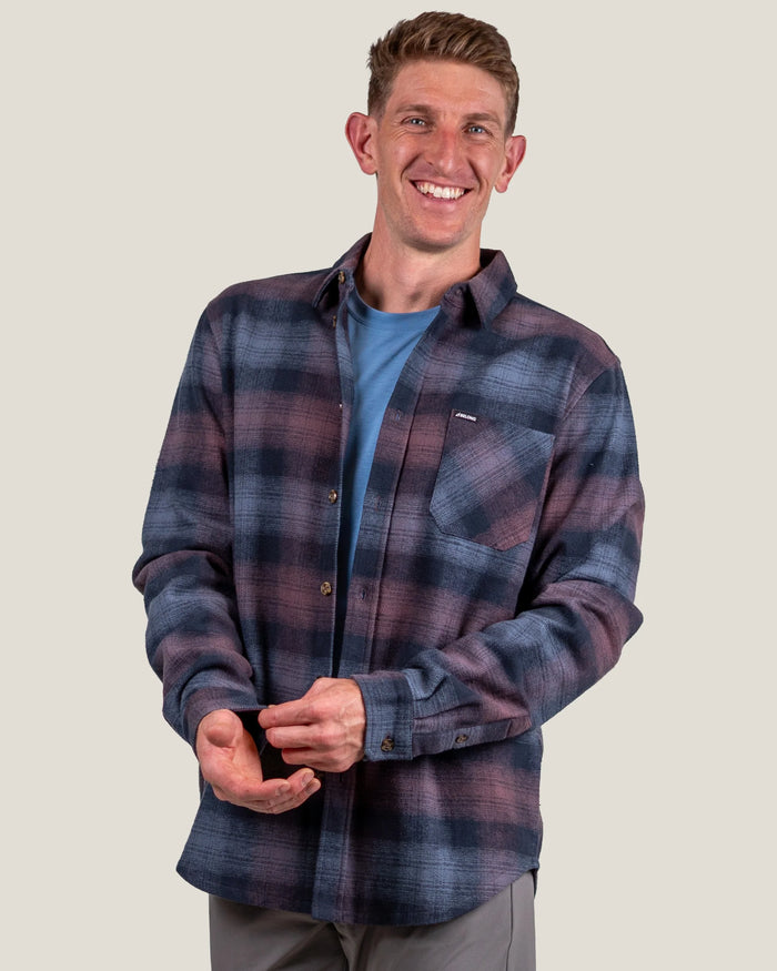 Men's plaid flannel shirt in navy and burgundy, worn open over blue tee, front angle view